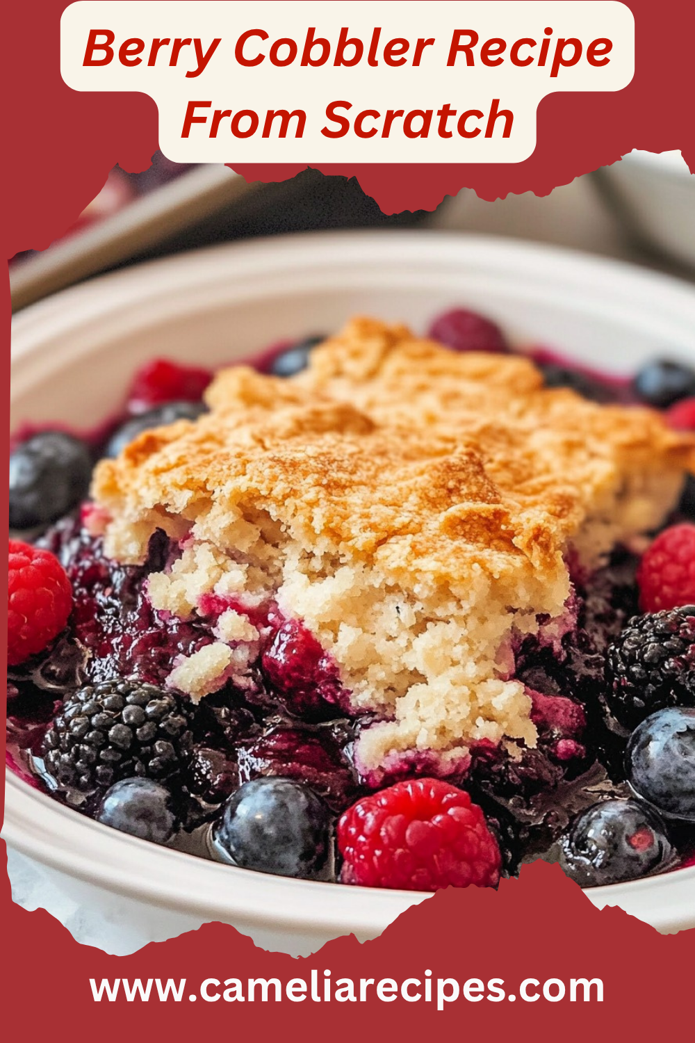 A freshly baked berry cobbler in a rustic dish with a golden-brown topping and vibrant mixed berries bubbling underneath.